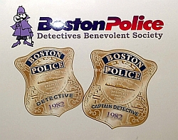 A pair of gold Boston Police Badges for Detective and Captian Detective dated 1982